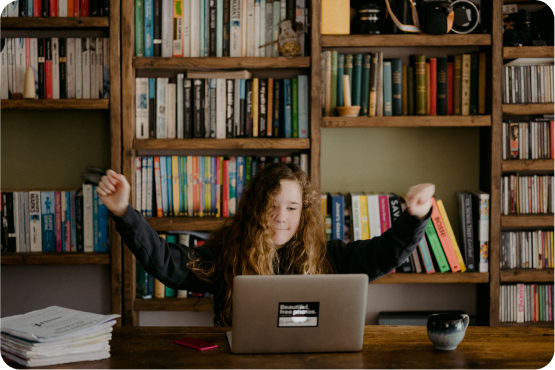 Student celebrating with arms raised showing personal growth